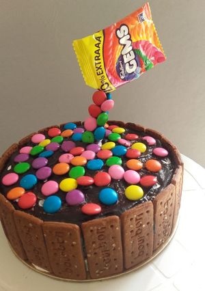 A picture of Gems Chocolate Cake for kids | Atta fruit and nut cake.