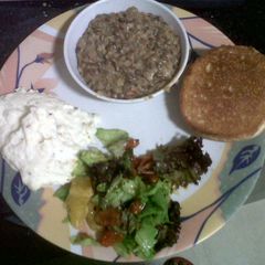 A picture of Creamy lentils with Mashed potatoes, Citrus Salad and Toasted Bun.
