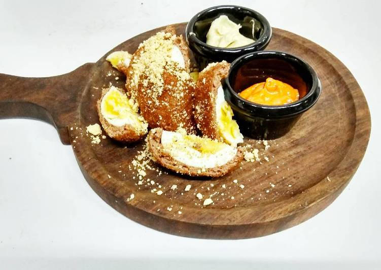 Scotch eggs with cocktail dip and cilantro peanut dip