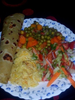 A picture of Chapati served with peas and veges.