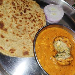 A picture of Paneer kofta with rich coconut and kaju gravy.