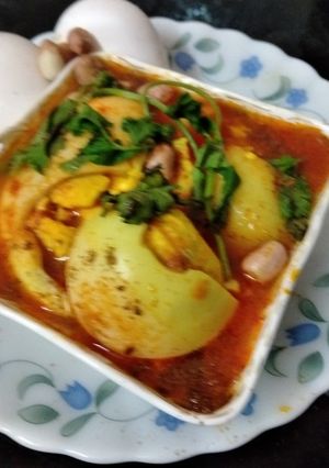 A picture of Egg Curry in peanuts khus khus gravy.
