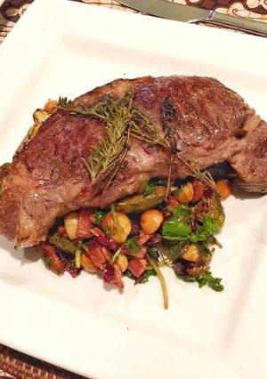 A picture of Sirloin steak with Balsamic glazed brussels sprouts with bacon, cranberry, walnut and blue cheese.