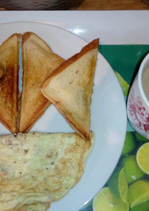 A picture of Toasted bread,fried Eggs and Hot Choco.