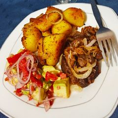 A picture of Pan roasted potatoes.....served with pan fried goat meat.