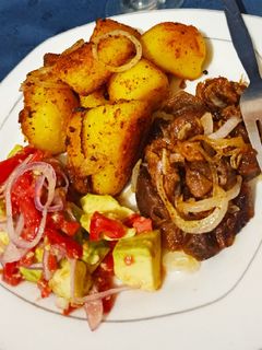 A picture of Pan roasted potatoes.....served with pan fried goat meat.