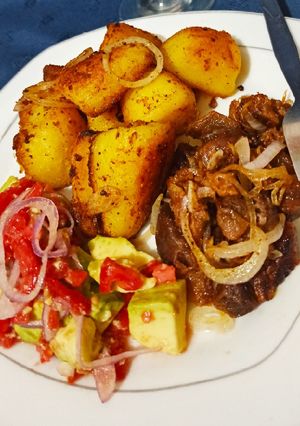 A picture of Pan roasted potatoes.....served with pan fried goat meat.