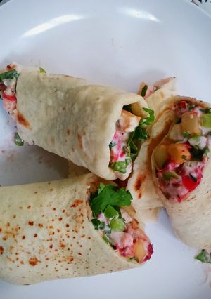 A picture of Chicken wrap with coleslaw (burrito).