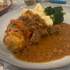 A picture of Slow cooker Beef & Bacon Stew with Red wine & rosemary served with rosemary dumpling.