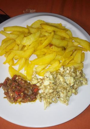 A picture of Fried chips with egg and sauce #KADUNACOOKOUT.