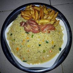 A picture of Indomine with carrots,green peas,chicken and Irish potatoes.