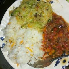 Carrot rice, steamed vegetables and beef stew A picture of Carrot rice, steamed vegetables and beef stew.
