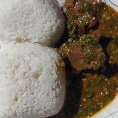 A picture of White rice and okra soup.