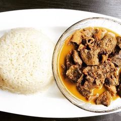 A picture of Goat offals pepper soup and white rice.