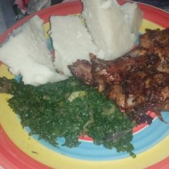 A picture of Ugali,Spinach and Pork.