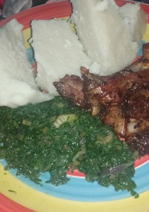A picture of Ugali,Spinach and Pork.