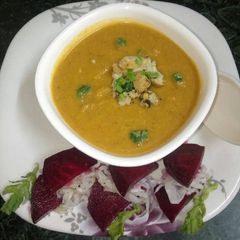 A picture of Moong daal soup with roasted cauliflower.