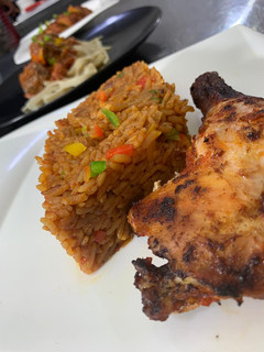 A picture of Jollof rice with grilled chicken.