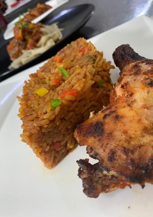 A picture of Jollof rice with grilled chicken.