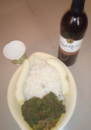 A picture of White rice with vegetable sauce and banana.