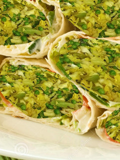 A picture of Stir fried Cabbage, green peas, bok choy stuffed Pita bread.