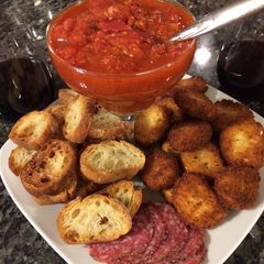A picture of Fried Goat Cheese w/Tomato, Garlic Red Wine Reduction.