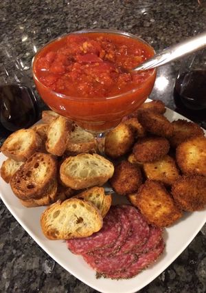A picture of Fried Goat Cheese w/Tomato, Garlic Red Wine Reduction.