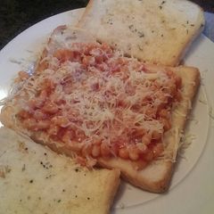 A picture of Eggy bread with beans an cheese.