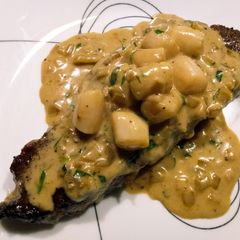 A picture of Steak, scallops, and cream.