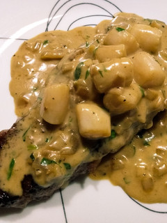A picture of Steak, scallops, and cream.