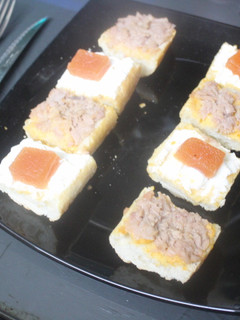 Una foto de Trozos de pan con atún, queso y membrillo