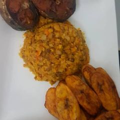 A picture of Porridge beans and fried plantain with fish.