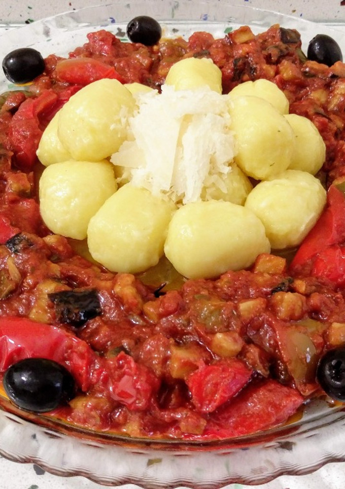 Una foto de Gnocchis de calabaza con pisto, aceitunas y parmesano