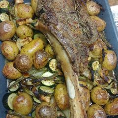 A picture of Tomahawk steak on Roasted veges.