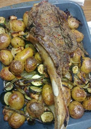 A picture of Tomahawk steak on Roasted veges.