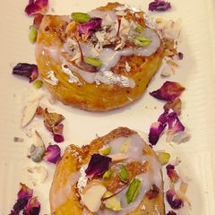 A picture of Soft bread roll with saffron mawa layer.