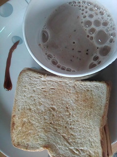 A picture of Toast bread & cocoa garnished with honey.