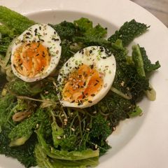 A picture of Savoy cabbage with soft boiled eggs and furikake.