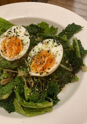 A picture of Savoy cabbage with soft boiled eggs and furikake.