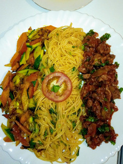 A picture of Spaghetti on tomato sauce,wet fry beef, sauteed vegetables..,.