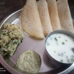 A picture of Vrat ka dosa with aloo sabzi and peanuts chutney and masala chanch.