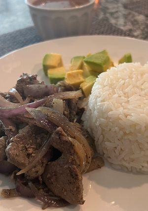 A picture of Beef liver with grilled onions.