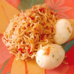 A picture of Jollof noodles and boiled egg.