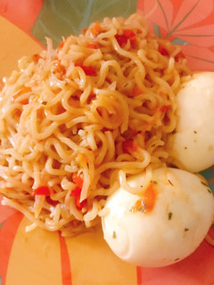 A picture of Jollof noodles and boiled egg.
