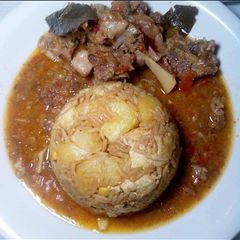 A picture of Jollof rice and ram pepper soup.