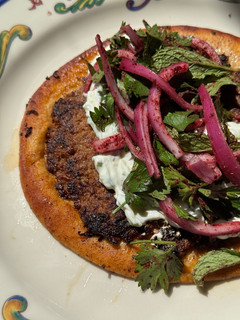 A picture of Smashed Beef Pita with Tzatziki & Sumac Salad.