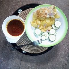 A picture of Chips with egg, cocumber & sauce.