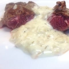 A picture of Lamb Steaks with Onion & Rosemary Sauce.