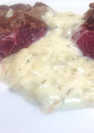 A picture of Lamb Steaks with Onion & Rosemary Sauce.