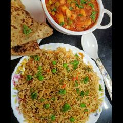 Matar Aloo with Biryani Rice and paratha A picture of Matar Aloo with Biryani Rice and paratha.